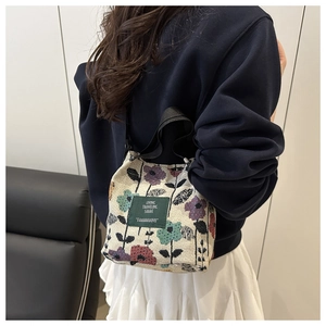 Detailed macro view of vintage floral jacquard fabric on stylish summer bucket bag
