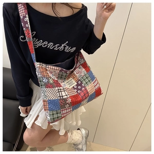 Detail of colorful patchwork corduroy tote bag with floral patterns and C'EST LA VIE label