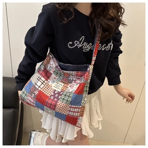 Close-up of patchwork tote bag with colorful plaid and floral patterns in detail