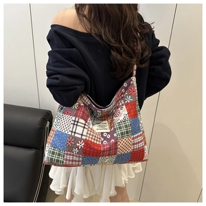 Detail of ethnic patchwork tote bag showing colorful floral prints and large capacity style