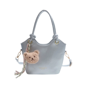 Chic light blue bucket bag with teddy bear charm and striped ribbon, 2025 trendy style