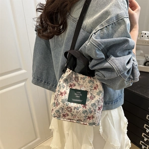 Vintage floral canvas tote bag with adjustable shoulder strap and green woven label