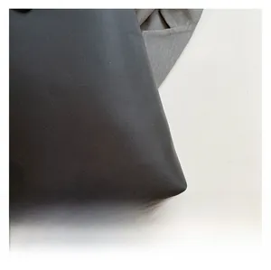 Close-up of premium black woven fabric texture with fine grain for stylish backpack