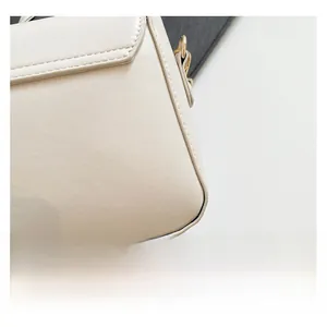 Detail of premium beige faux leather bag with gold D-ring and precise stitching