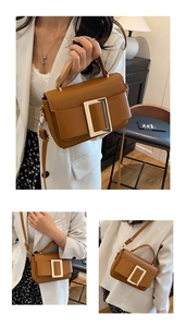 Detail showing vintage caramel brown leather handbag with bold gold buckle and handle