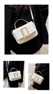 Detail shot of the iconic gold buckle and premium leather texture of the white handbag