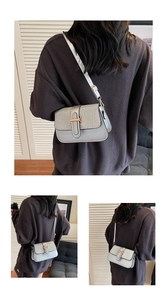 Detail view of stylish crossbody bag with silver sequins and gold H-shaped clasp