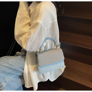 Chic light blue and beige crossbody bag with textured honeycomb flap and gold hardware