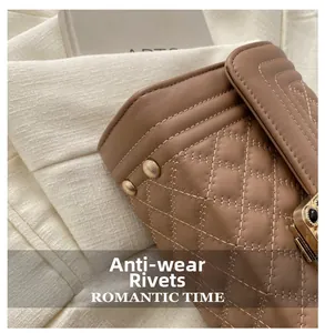 Detail of quilted leather bag with protective metal rivets and vintage gold clasp hardware