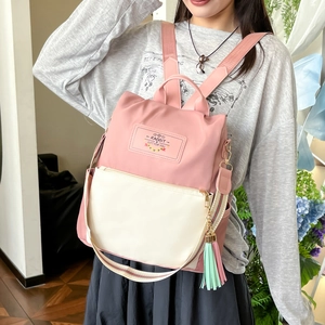 Minimalist pink and beige nylon backpack with Rabbit logo for campus and daily commuting