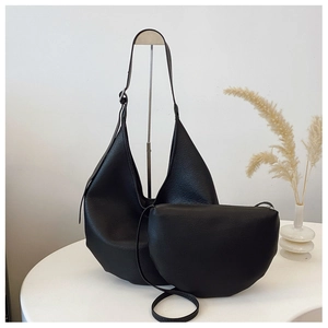 Detail shot of black litchi pattern leather bucket bag set with shoulder and crossbody bags