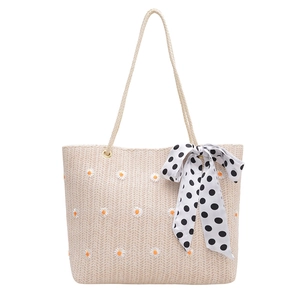 Large straw tote bag with daisy embroidery and polka dot ribbon for summer travel