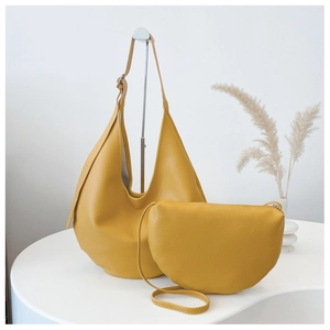 Detail of yellow lychee texture leather hobo shoulder bag and small crossbody pouch set
