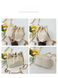 Detail view of woven bucket bag with gold chain strap and elegant pearl drawstring accents
