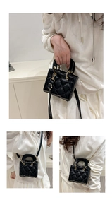 Detail view of mini quilted handbag with metal top handles and detachable shoulder strap