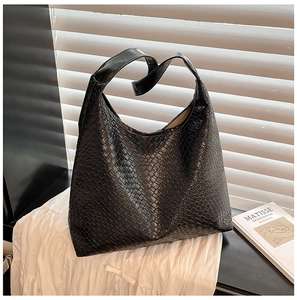 Close-up of black woven texture on a large hobo shoulder bag with matte finish