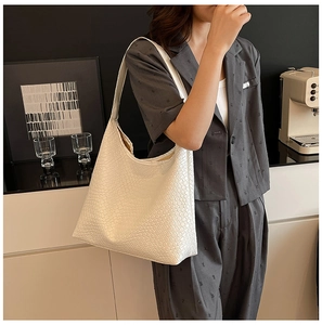 Detailed view of a white woven texture on a large capacity hobo shoulder bag for women