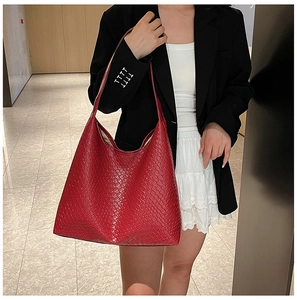 Detailed view of the woven leather texture on the red large shoulder tote bag