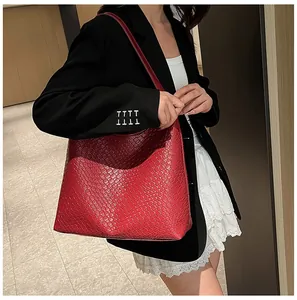 Detailed view of red woven leather tote bag with elegant checkered pattern for daily use