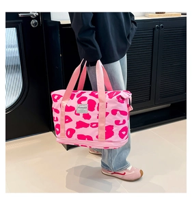 Pink leopard print travel bag with spacious interior and zipper expansion layer