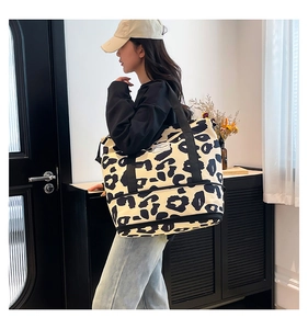 Close-up of leopard print canvas tote bag featuring large capacity and brand label detail