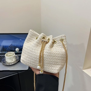Fashionable beige woven drawstring bucket bag with gold chain and pearl charms for summer