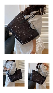 Close-up of black quilted tote bag featuring delicate white bow patterns and glossy finish