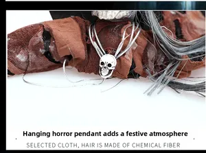 Detail of Halloween ghost decoration showing skull pendant and aged brown fabric texture