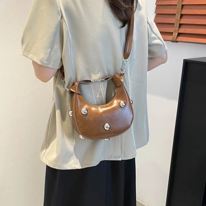 Brown crescent shoulder bag with silver rivet studs and detachable leather strap