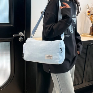 Versatile light blue canvas cylinder crossbody bag for women with wide shoulder strap