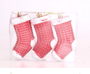 Detailed view of red and white plastic Christmas stocking ornaments in clear packaging
