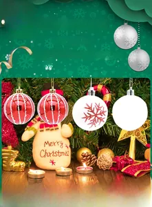 Close-up of red and white painted Christmas balls with snow patterns on a festive tree branch