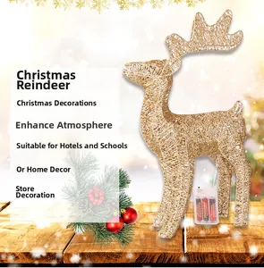 Close-up of golden lighted Christmas reindeer decor with battery box on wooden table