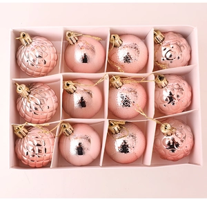 Close-up of 12 pink Christmas ornaments with matte, glossy, and textured finishes