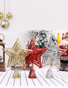 Detailed view of glittered gold, red, and silver star tree toppers with spring base