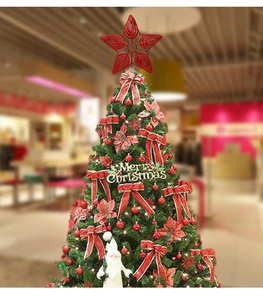 Red glitter hollow star tree topper placed on a Christmas tree with Merry Christmas sign