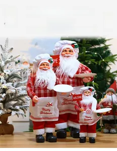 Detail of chef Santa Claus doll holding a welcome sign and white serving tray