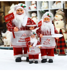 Three Santa Claus chef figurines in various sizes with Merry Christmas aprons and welcome signs