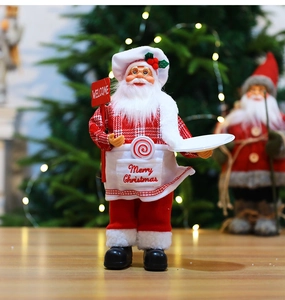 Macro detail of Chef Santa figurine holding a welcome sign and tray for Christmas decor
