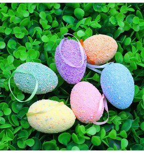 Macro detail of six colorful Easter egg ornaments with textured matte finish and silk ribbons