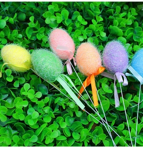 Colorful Easter egg picks with fuzzy glitter texture and ribbon bows on green leaves