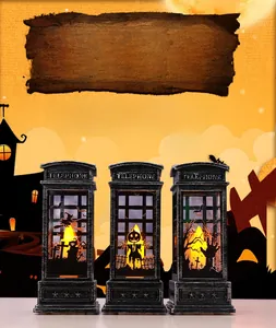 Close-up of Halloween telephone booth lanterns with witch and pumpkin LED silhouettes
