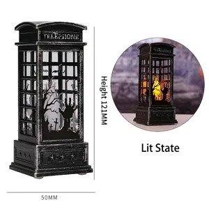 Macro detail of Halloween telephone booth lantern showing LED light and spooky silhouettes