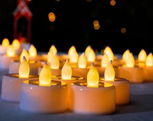 Detail of warm white LED tea light candles with realistic flickering flame effect