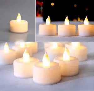 Macro detail of warm yellow LED tea lights with flame-shaped bulbs for holiday decor