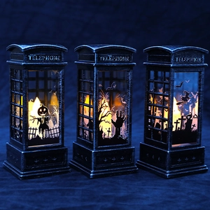 Three vintage Halloween telephone booth lanterns with LED candles and pumpkin silhouettes
