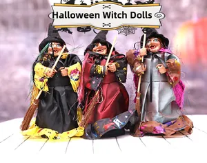 Detailed view of three Halloween witch dolls with sequined hats and wooden brooms