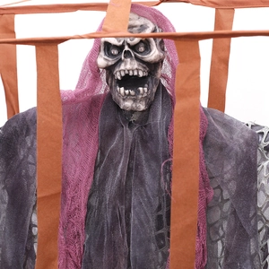 Hanging Halloween skeleton ghost in cage with glowing eyes and purple mesh headscarf