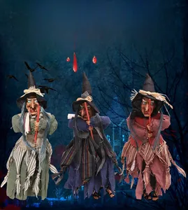 Three hanging witch dolls with broomsticks in red, blue, and green for Halloween decoration