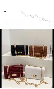 Detail of four stone patterned shoulder bags in black, brown, wine red and ivory white